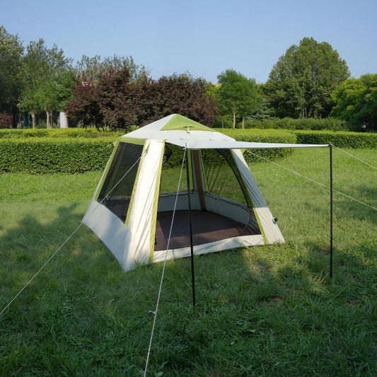 Tent with screen porch on grassy area with trees in the background
