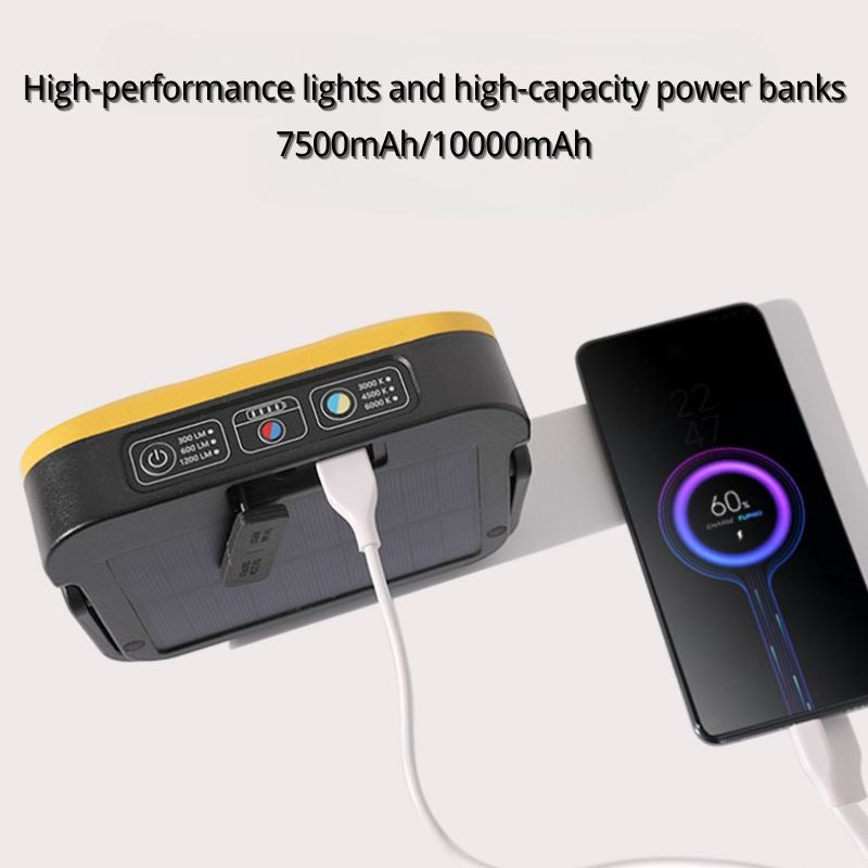 Power bank with solar panel and phone charging cable, displaying battery levels on a white background.