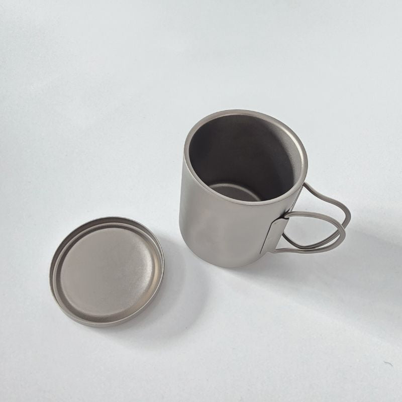 Titanium outdoor cup with lid and foldable wire handle - example of customizable prototype in Boertala Outdoor OEM process