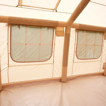 Beige tent interior with windowed panels and wooden beams