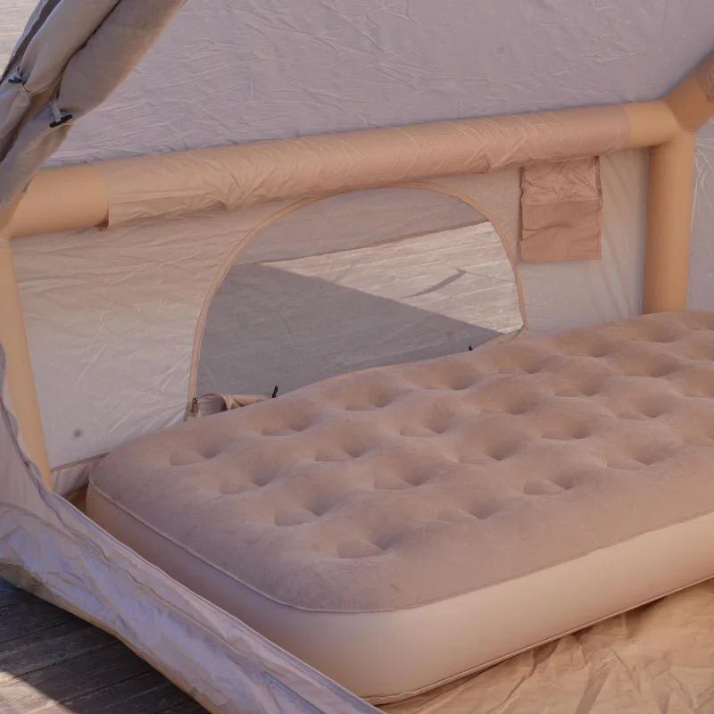 Inflatable mattress inside a tent with beige interior