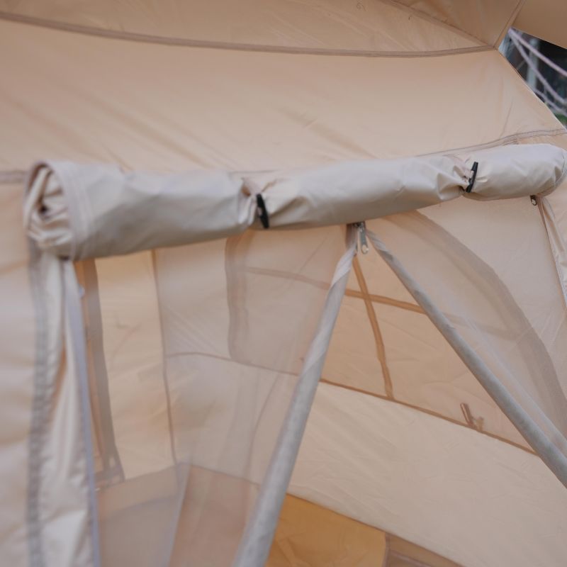 Inside view through arched mesh window of beige family inflatable camping tent, spacious for 6 people glamping

