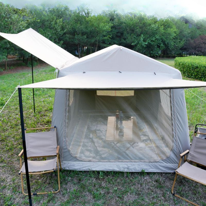 Quick setup beige ridge inflatable tent featuring hexagonal blackout and mesh porch with chairs and table in natural outdoor setting

