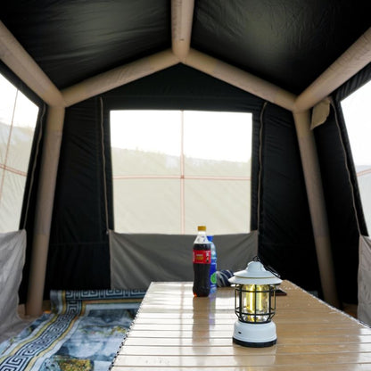 Quick setup beige ridge inflatable tent featuring hexagonal blackout and mesh porch with chairs and table in natural outdoor setting


