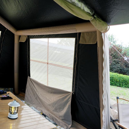 Inside a tent with a lantern on a wooden surface, showing an outdoor setting.