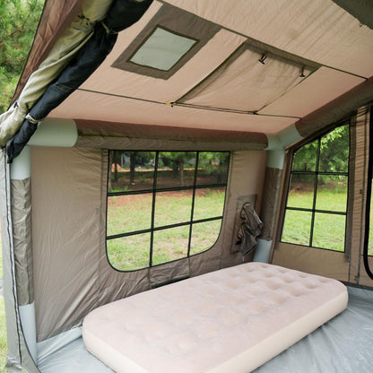 Camping tent interior with an inflatable mattress and windowed sides.