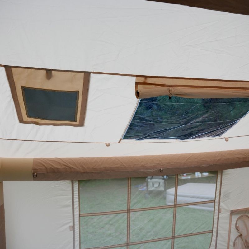 Close-up of a tent with wooden frames and glass panels
