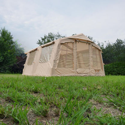 Beige camping tent with mesh windows on a grassy area with trees in the background