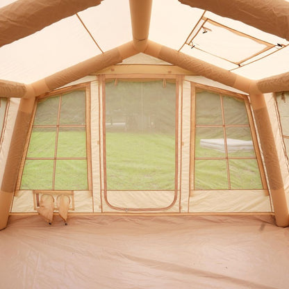 Inflatable tent interior with mesh windows and beige walls.