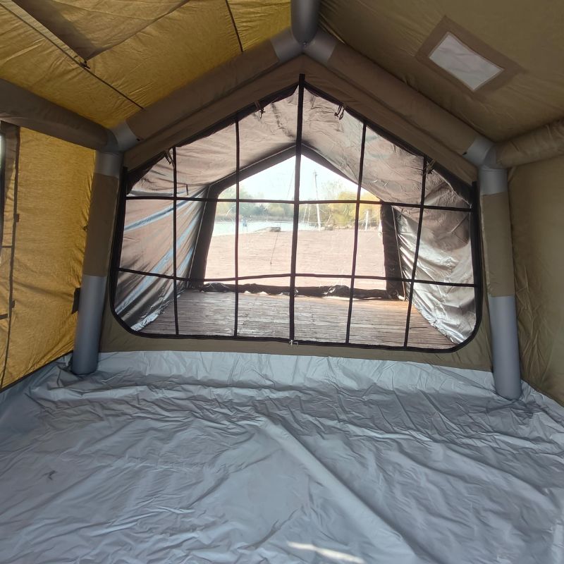 Interior of a tent with a window showing an outdoor view.