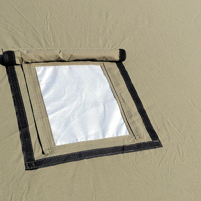 Window of a beige tent with black frame and white interior