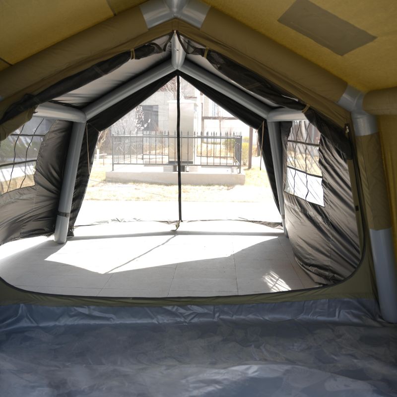 Inflatable tent with a clear window showing an outdoor setting.