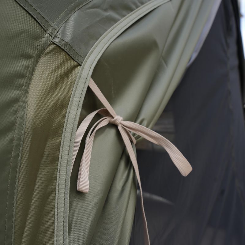 Close-up of a green fabric with a pink ribbon tied around it.