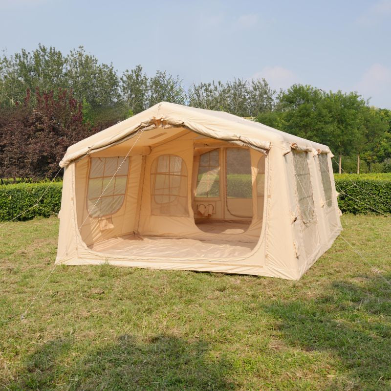 Beige tent with mesh windows on a grassy area with trees in the background