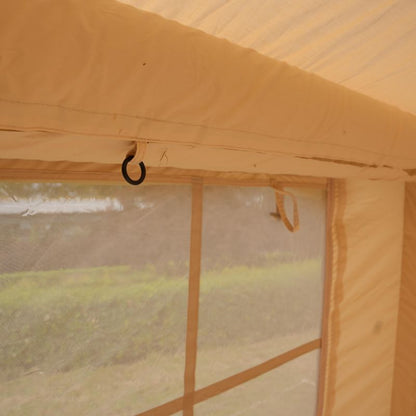 Partial view of a yellow tent with a blurred outdoor background