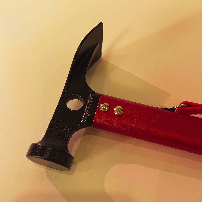 Red axe with a black head on a beige background