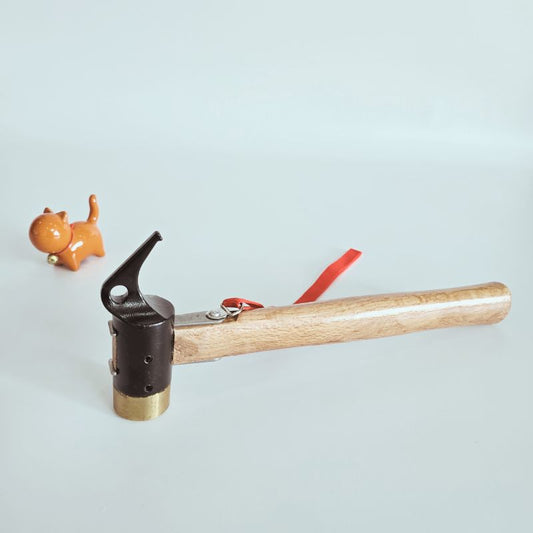 Hammer with wooden handle and metal head on a light blue background