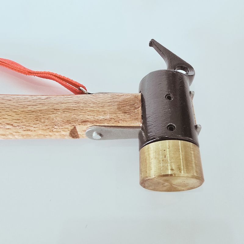 Close-up of a wooden bow with a brass nocking point on a light blue background