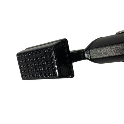 Black metal tool with textured surface on a white background