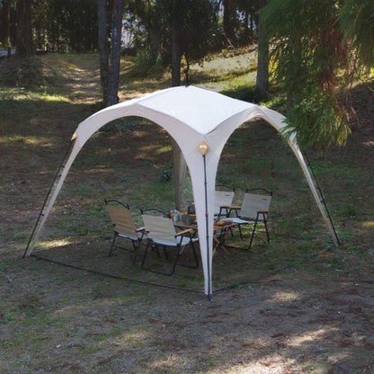 Outdoor canopy tent set up in a grassy area with chairs and a table underneath.