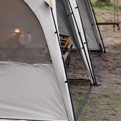 Close-up of a tent with a view into a room inside, set up outdoors.