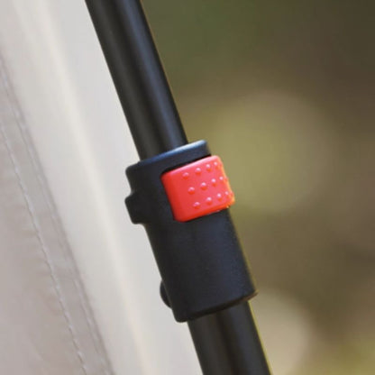 Close-up of a black pole with a red and gray connector against a blurred background