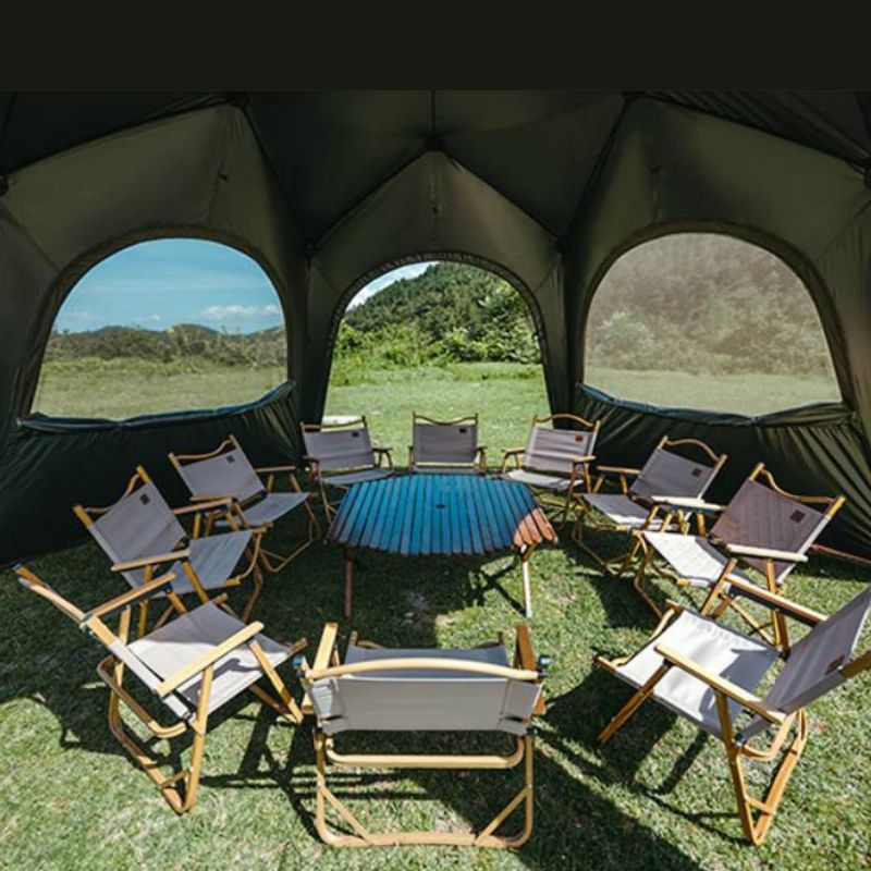 Camping tent interior with chairs and a table set up outdoors.