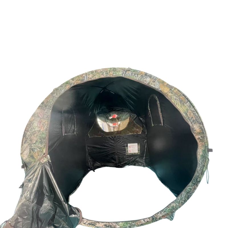 Camouflage hunting blind with a person inside on a white background
