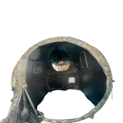 Camouflage hunting blind with a person inside on a white background