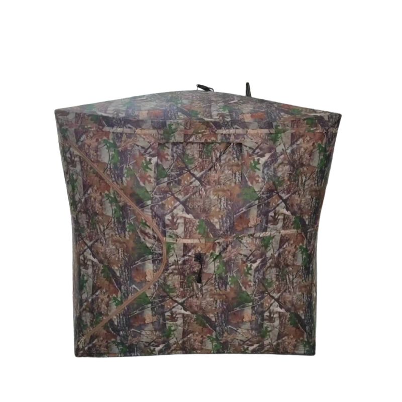 Camouflage cube hub-style hunting blind with 360-degree one-way see-through mesh windows and fiberglass poles on white background