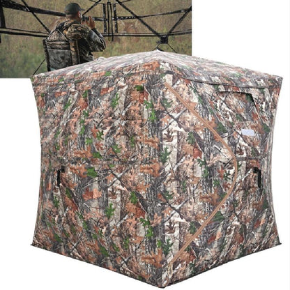 Camouflage hunting blind with a person in camouflage gear in the background