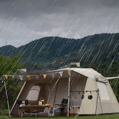 Tent set up in the rain with mountains in the background