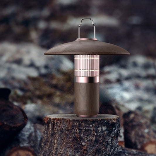Decorative lantern on a wooden stump with a blurred natural background