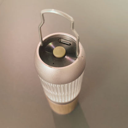 Portable light with a handle on a plain background