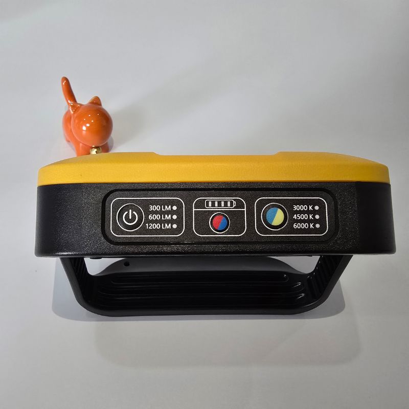 Yellow and black device with control panel on a gray background