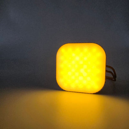 Square yellow light bulb on a dark background