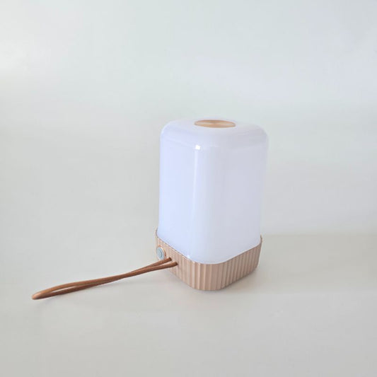 White and wooden lamp on a light gray background