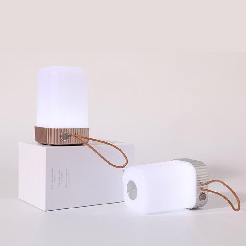 Portable lamp with a white base and brown accents on a light beige background