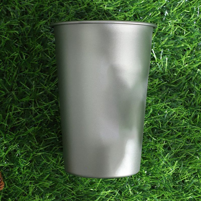 Metal cup on a grass background
