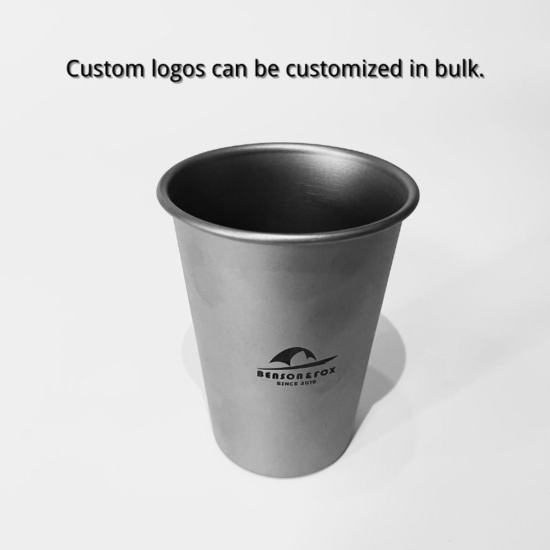 Silver metal cup with a logo on a white background