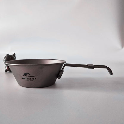 Metal camping pot with handle on a white background