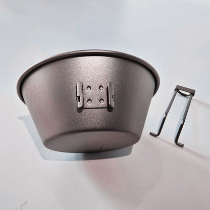Metal feed bowl with a holder on a light gray background