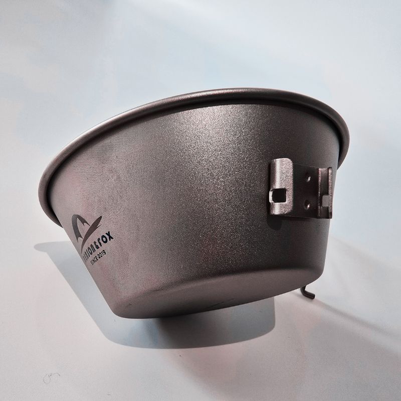 Metal feed bowl with a strap on a white background