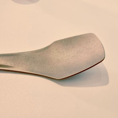 Wooden spoon on a beige background
