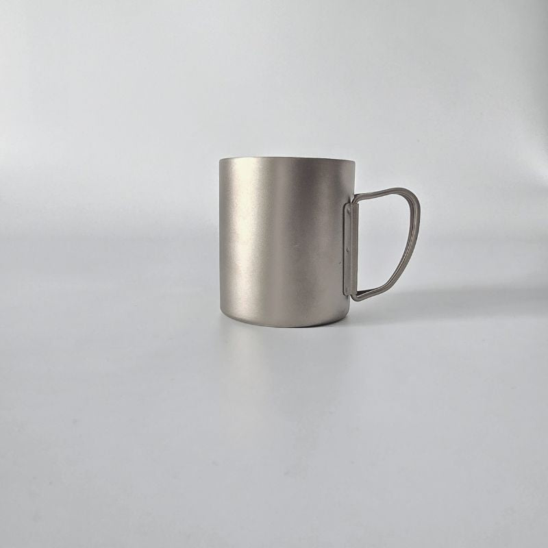 Silver metal mug on a light gray background
