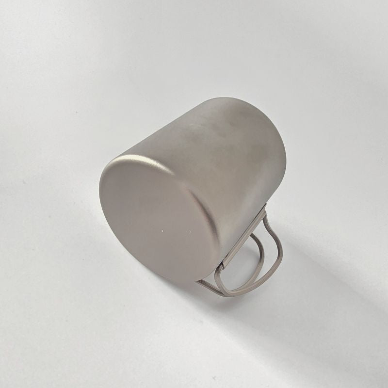 Silver ring with a textured surface on a light gray background