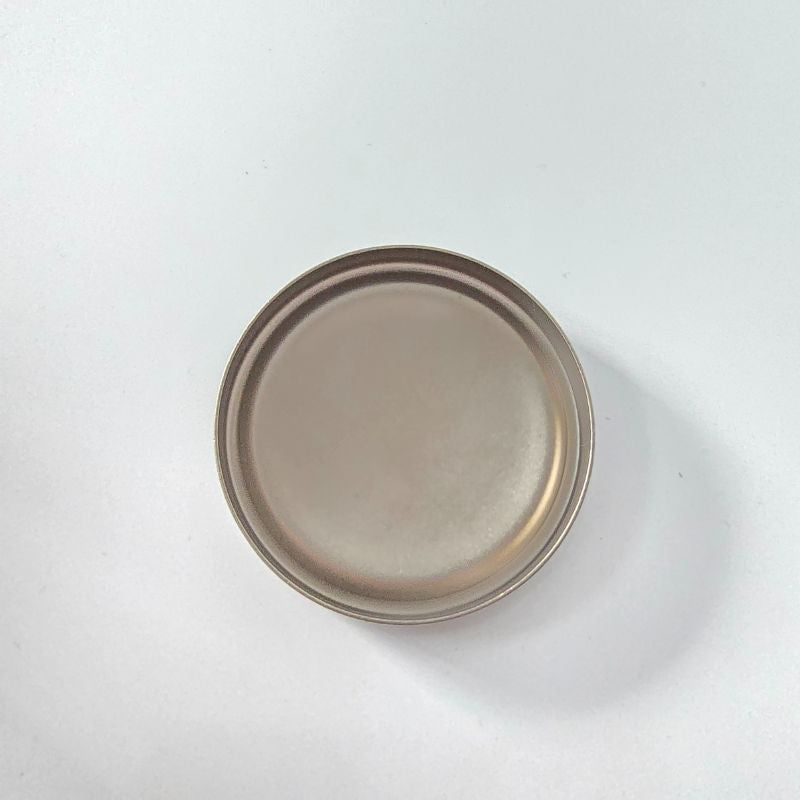 Round ceramic plate with a brownish-beige glaze on a white background