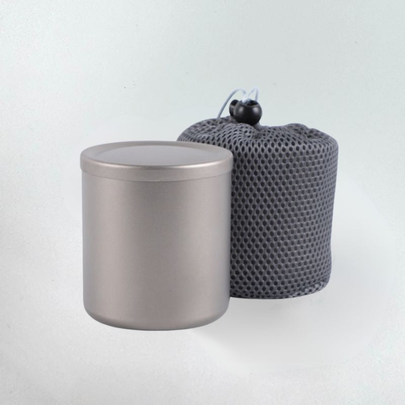 Metal canister and textured gray bag on a light gray background