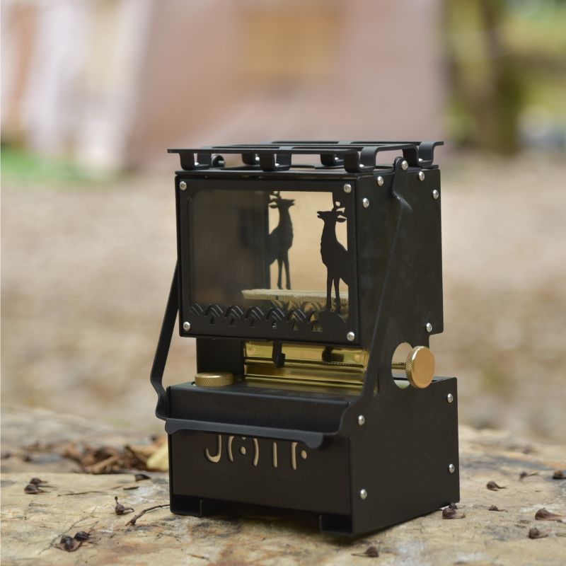 Compact black kerosene pressure stove lantern with wildlife deer silhouette, brass accents, and portable handle on white background

