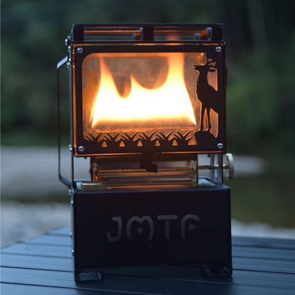 Portable fire pit with deer design on a wooden surface at night